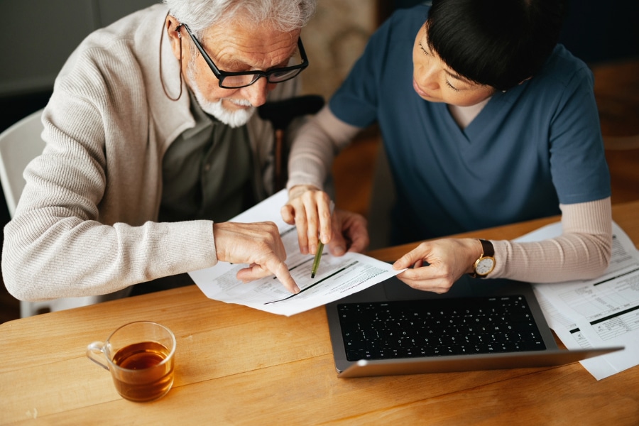 Reviewing medical bill with old man