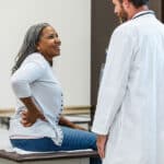 Woman with back pain at the doctor