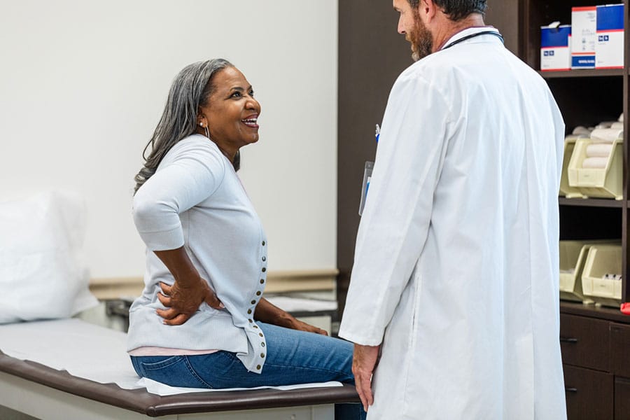 Woman with back pain at the doctor