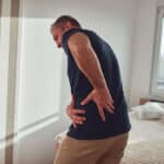 Man with Sore Hip in Bedroom